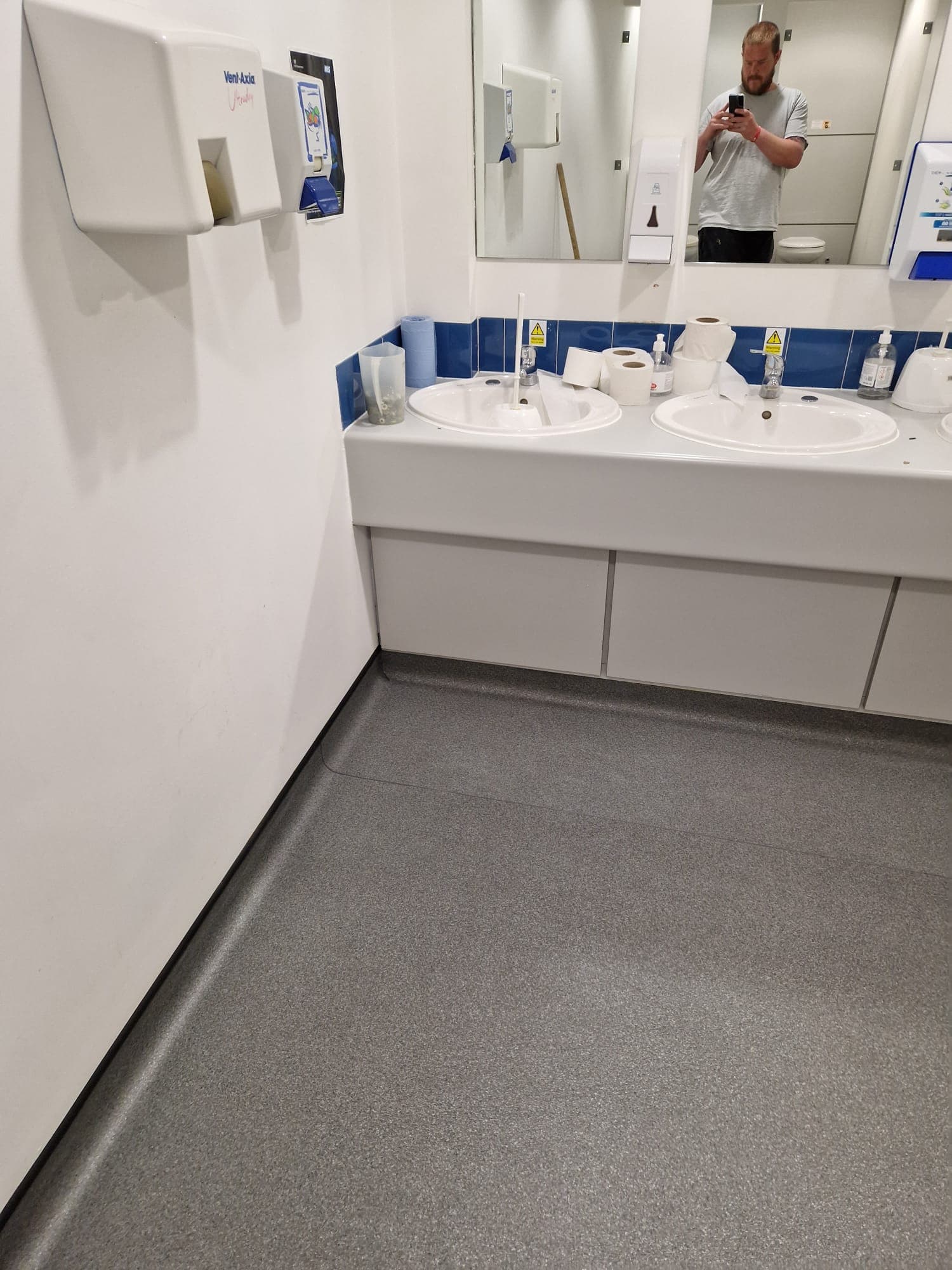 Two-pack epoxy resin floor poured edge-to-edge in a commercial unit
