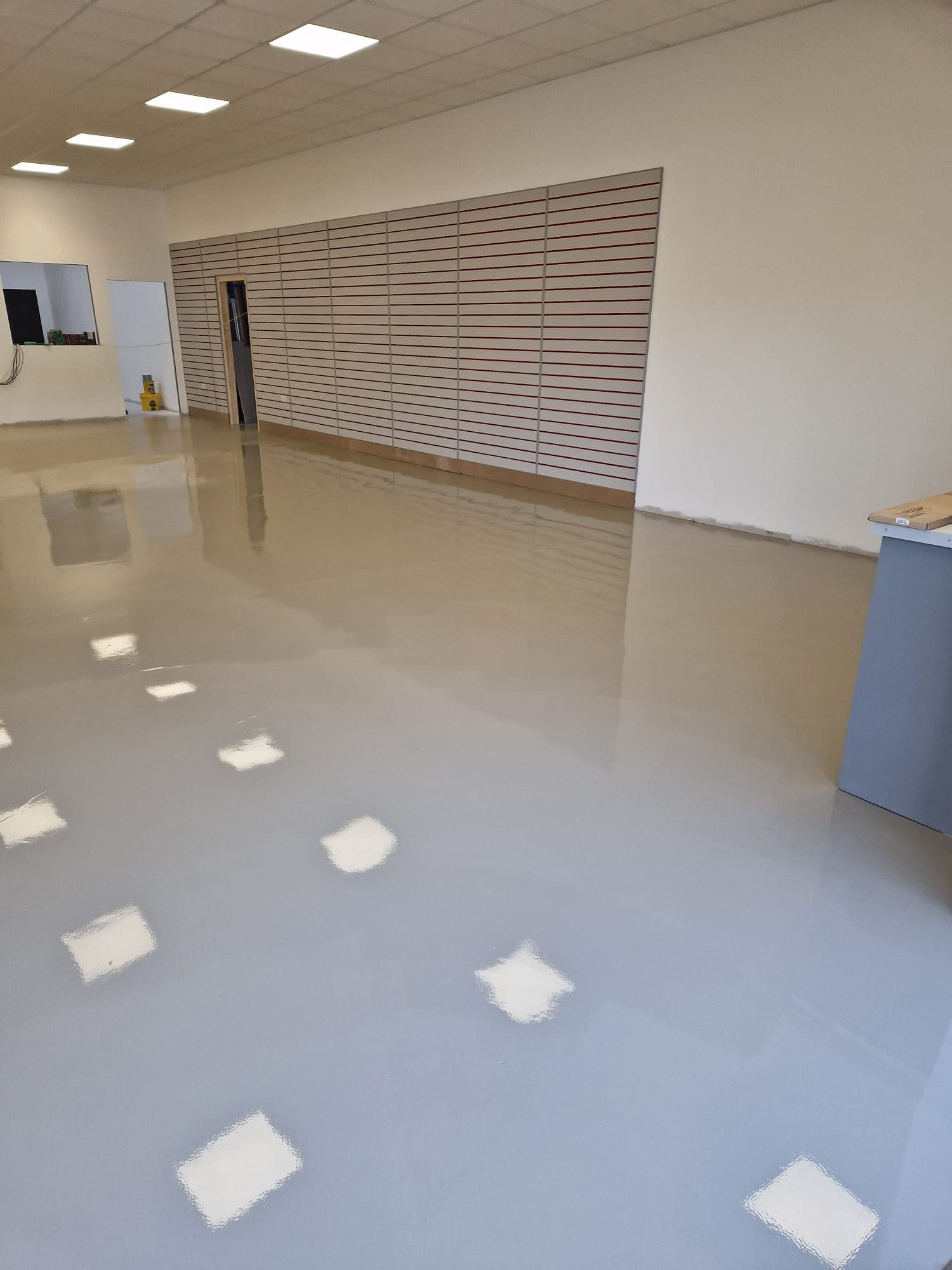 High-gloss epoxy finish across Derby retail back-of-house